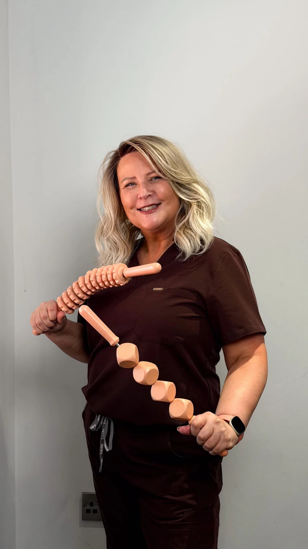Alison James holding wood therapy tools